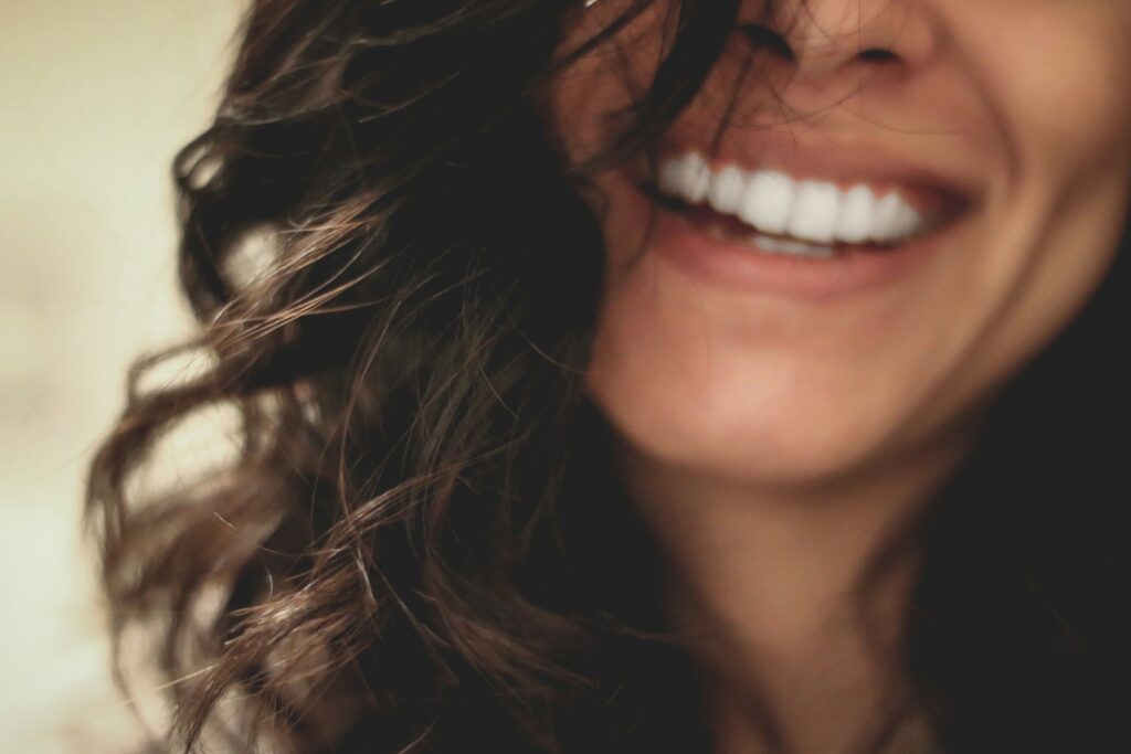 The smile of a dark-haired woman