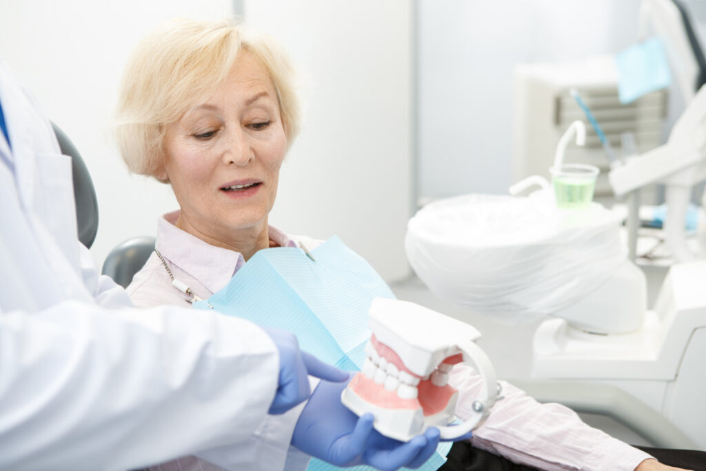 Professional dentist and his senior patient