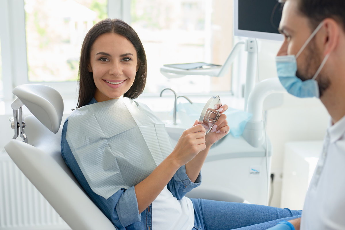 portrait of happy client and dentist looking at the camera in the hospital