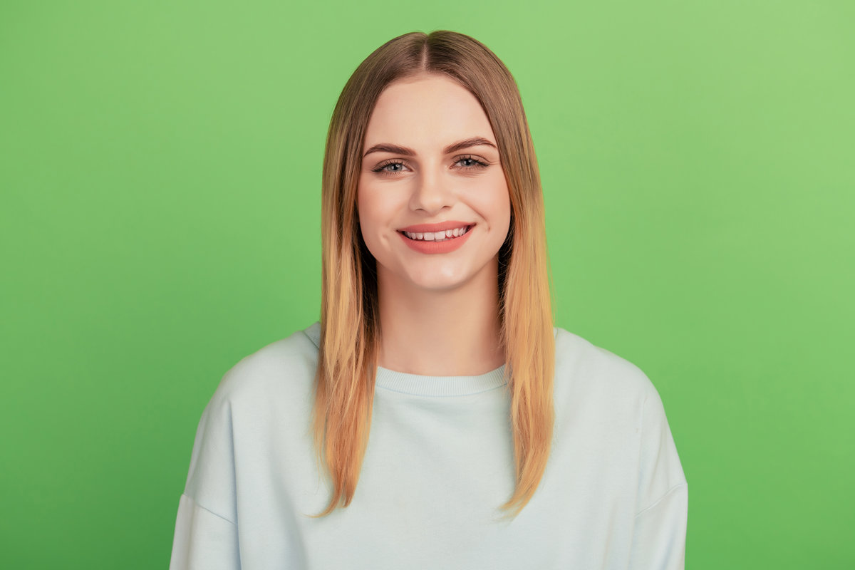 Photo of young cheerful girl happy positive smile clinic oral care teeth isolated over green color background.